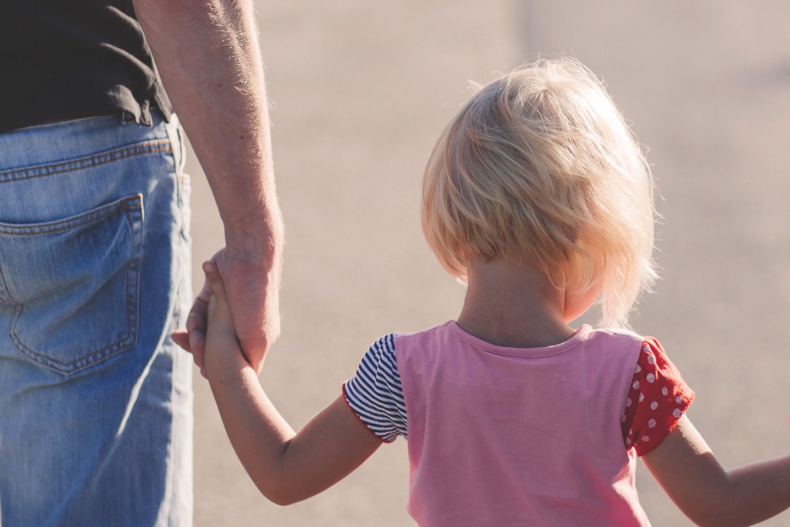 Father and daughter holding hands
